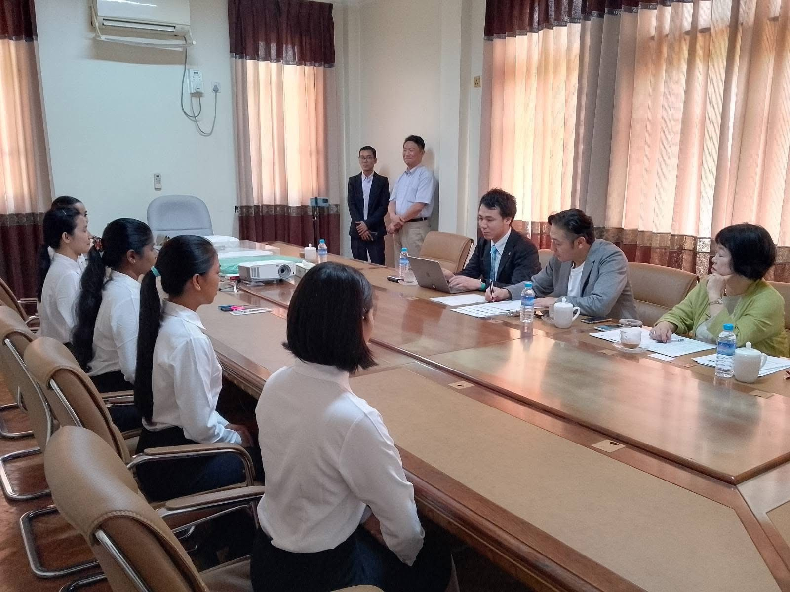 People gathered around a conference table in a meeting room